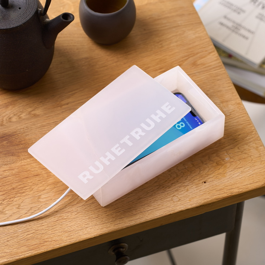 Geöffnete rosafarbene Ruhetruhe mit Smartphone